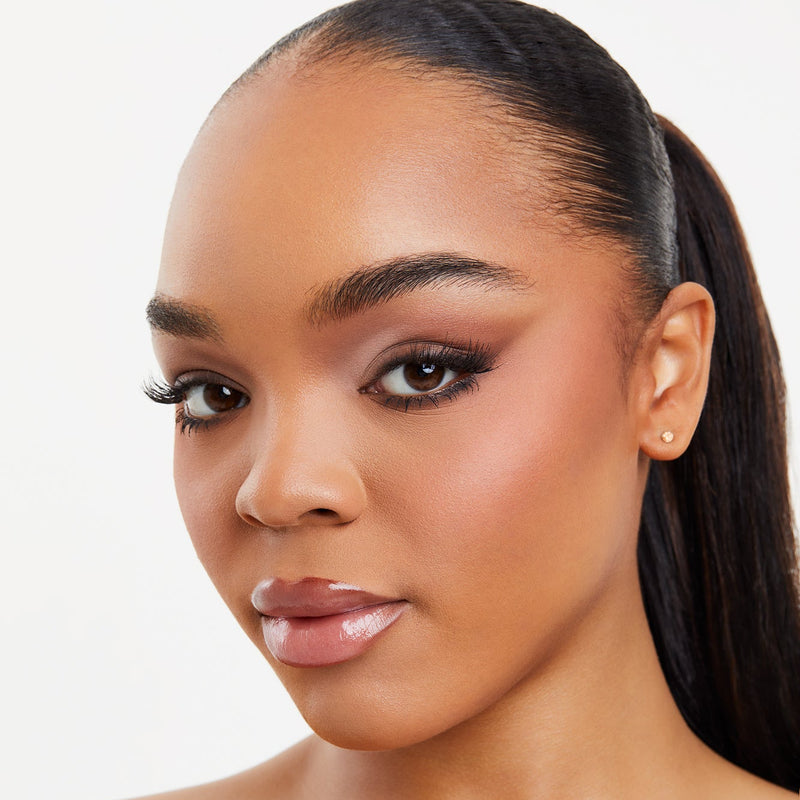 Close-up of a model's lips wearing TRU SKN Soft Silk Cream Lip Gloss in Wildberry. 